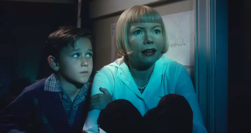 Michelle Williams as Mitzi looks wonderstruck as her son looks at her