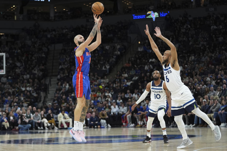 Detroit Pistons guard Evan Fournier shoots as Minnesota Timberwolves guard Jordan McLaughlin (6) defends during the first half of an NBA basketball game, Wednesday, March 27, 2024, in Minneapolis. (AP Photo/Abbie Parr)