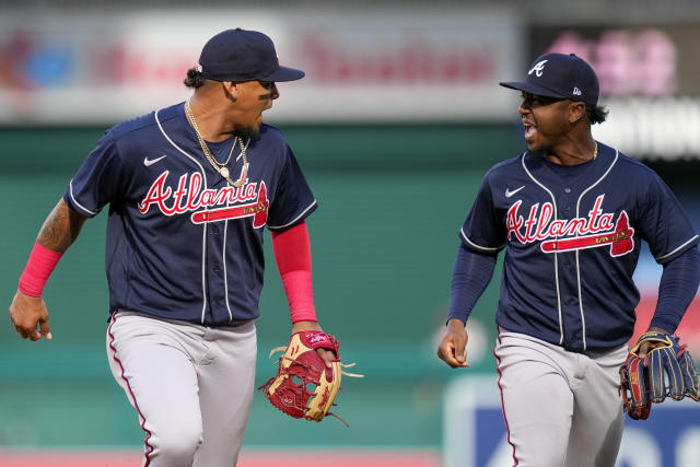 Atlanta Braves' Orlando Arcia, left, and Ozzie Albies react as the run to the dugout during the third inning of a baseball game against the Washington Nationals at Nationals Park, Saturday, April 1, 2023, in Washington. (AP Photo/Alex Brandon)
