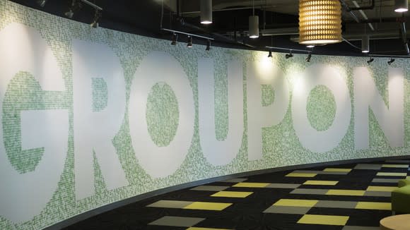 A light green tile wall that reads GROUPON at the company's headquarters.