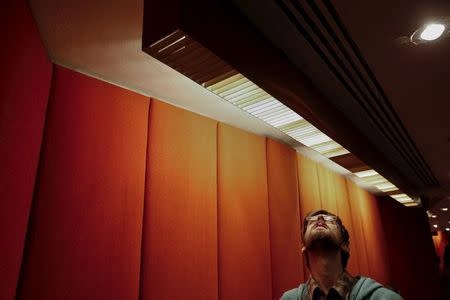 A man examines a lighting fixture inside the Trans World Airlines Flight Center at John F. Kennedy Airport in the Queens borough of New York, October 18, 2015. REUTERS/Shannon Stapleton