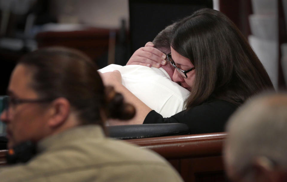 Convicted killer Richard Darren Emery is embraced by defense attorney Stephanie Zipfel, right, after a jury imposed a death sentence for the December 2018 killing of Emery's girlfriend and her family in St. Charles Circuit Court on Tuesday, Oct. 4, 2022, in St. Charles, Mo. Emery shot 61-year-old Jane M. Moeckel, her two grandchildren Zoe Kasten, 8, and Jonathan Kasten, 10, and the children's mother, Kate Kasten, 39. (Robert Cohen/St. Louis Post-Dispatch via AP)