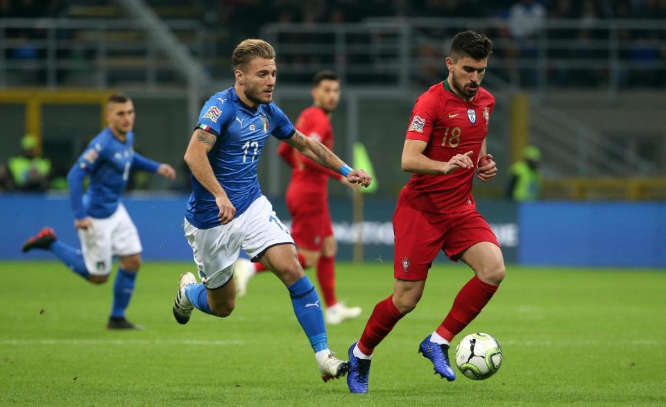 Italy's Ciro Immobile, left, challenges for the ball with Portugal's Ruben Neves during the UEFA Nations League soccer match between Italy and Portugal at the San Siro Stadium, in Milan, Saturday, Nov. 17, 2018. (Matteo Bazzi/ANSA Via AP)