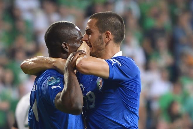 TOPSHOTS Italian defender Leonardo Bonucci (R) puts his hand on Mario Balotelli's mouth after Balotelli scored during the Euro 2012 football championships match Italy vs Republic of Ireland on June 18, 2012 at the Municipal Stadium in Poznan. AFP PHOTO / FABRICE COFFRINIFABRICE COFFRINI/AFP/GettyImages