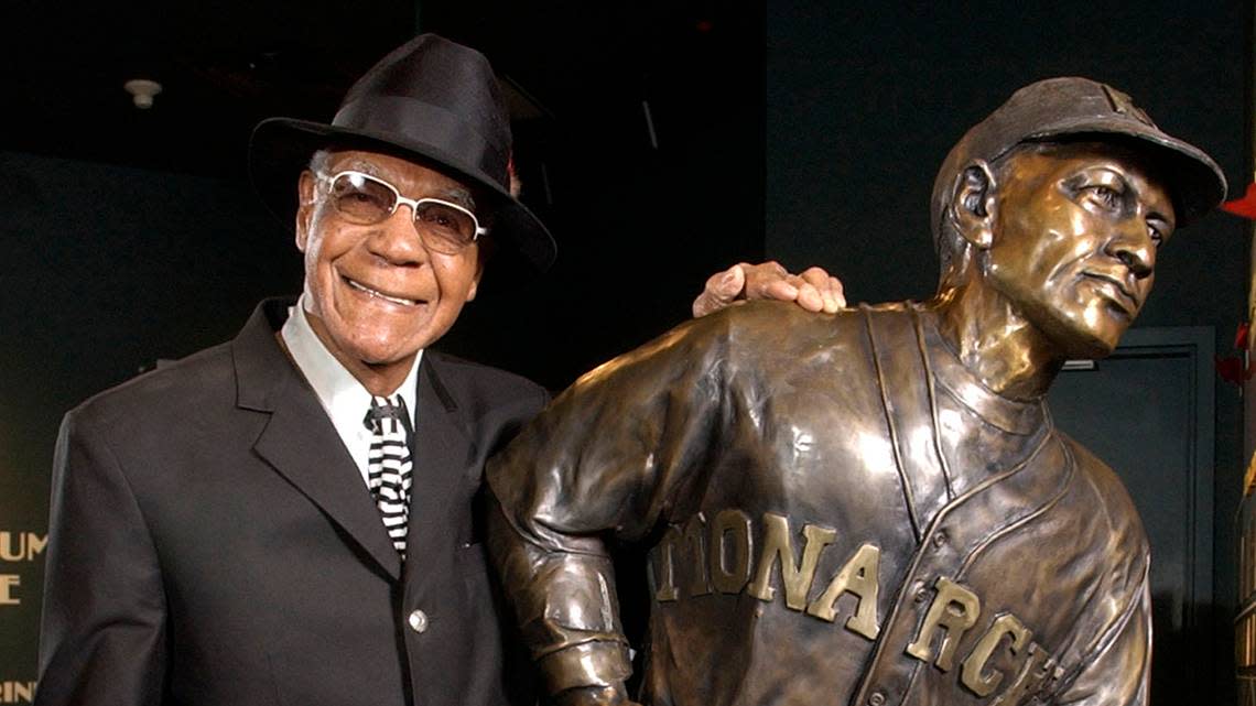 In this Feb. 11, 2005 photo, Buck O’Neil stands with a statue of himself in the Negro League Baseball Museum in Kansas City.