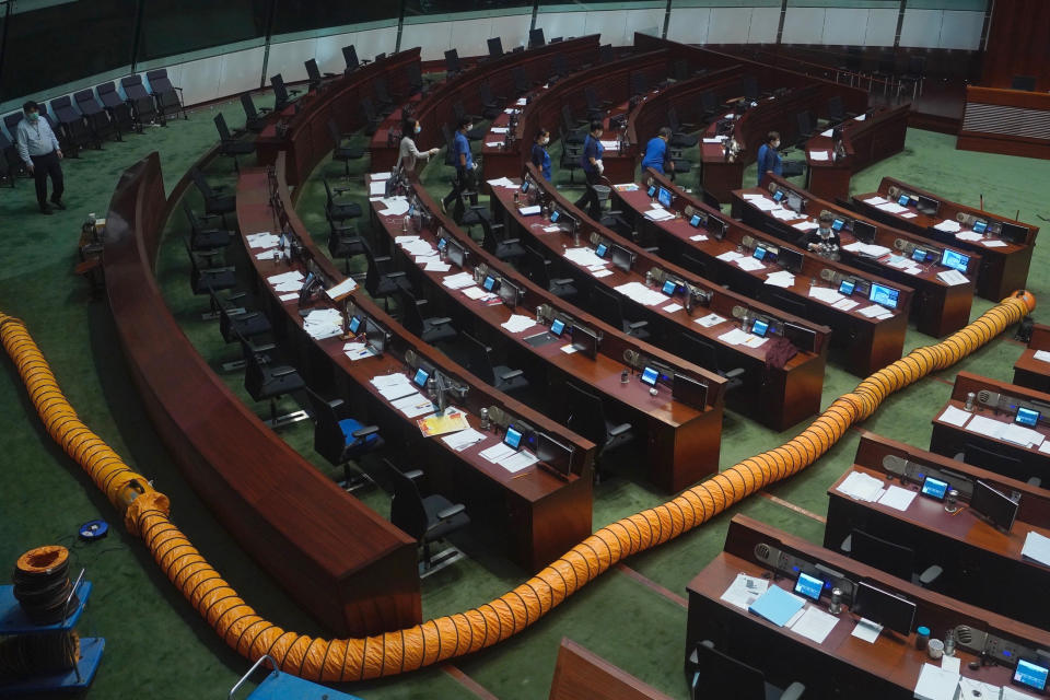 A ventilation pipe is placed on walkways at the main chamber of the Legislative Council after a pro-democracy lawmaker dropped a pot of pungent liquid in the chamber in Hong Kong, Thursday, June 4, 2020. A Hong Kong legislative debate was suspended Thursday afternoon ahead of an expected vote on a contentious national anthem bill after pro-democracy lawmakers staged a protest. (AP Photo/Vincent Yu)