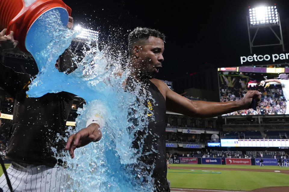 San Diego Padres' Xander Bogaerts is doused in an energy drink after hitting a walk off two-run home run during the ninth inning of a baseball game against the Colorado Rockies, Tuesday, Sept. 19, 2023, in San Diego. (AP Photo/Gregory Bull)