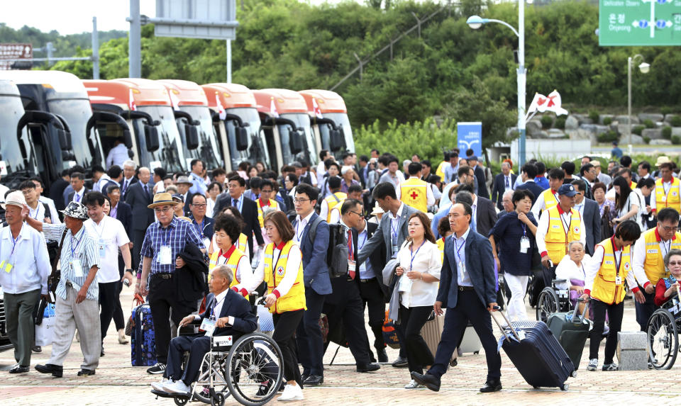 South Koreans leave for North Korea to take part in family reunions with their North Korean family members at the customs, immigration and quarantine (CIQ) office in Goseong, South Korea, Monday, Aug. 20, 2018. About 200 South Koreans and their family members prepared to cross into North Korea on Monday for heart-wrenching meetings with relatives most haven't seen since they were separated by the turmoil of the Korean War. (Korea Pool/Yonhap via AP)