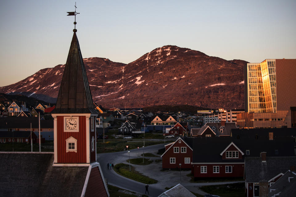 FILE - In this Monday, July. 31, 2017 file photo the sun sets over Nuuk, Greenland. A spokeswoman for Denmark's royal palace says U.S. President Donald Trump's decision to postpone a visit to Denmark next month was "a surprise." Trump announced his decision by tweet after the Danish prime minister dismissed the notion of selling Greenland to the U.S. as "an absurd discussion." (AP Photo/David Goldman, File)