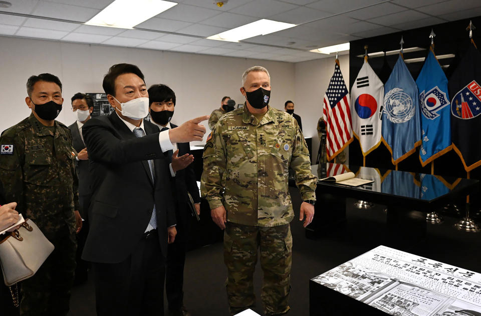 FILE - In this photo provided by South Korean President-elect office via Yonhap News Agency, South Korean President-elect Yoon Suk Yeol, second from left, speaks as Gen. Paul LaCamera, right, commander of USFK and the South Korea-U.S. Combined Forces Command, listens during his visit to Camp Humphreys in Pyeongtaek, South Korea, on April 7, 2022. Yoon takes office as South Korea's president Tuesday, May 10 amid heightened animosities over North Korea's nuclear program. During his election campaign, the conservative Yoon said he would teach North Korean leader Kim Jong Un some manners and sternly cope with his provocative missile tests with a strengthened alliance with the United States. (South Korean President-elect office/Yonhap via AP, File)