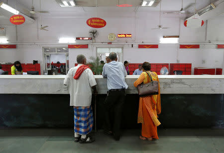 Customers wait to deposit their money inside a post office in New Delhi, India, October 21, 2016. Picture taken October 21, 2016. REUTERS/Adnan Abidi