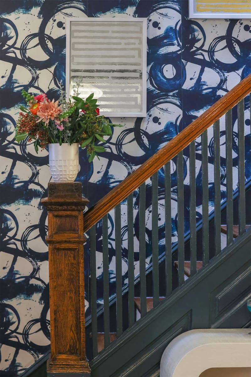 Flowers in vase on stair baluster.