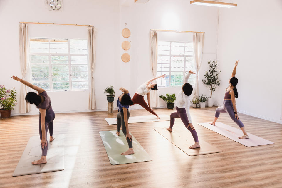 Group of people practicing yoga in a bright studio