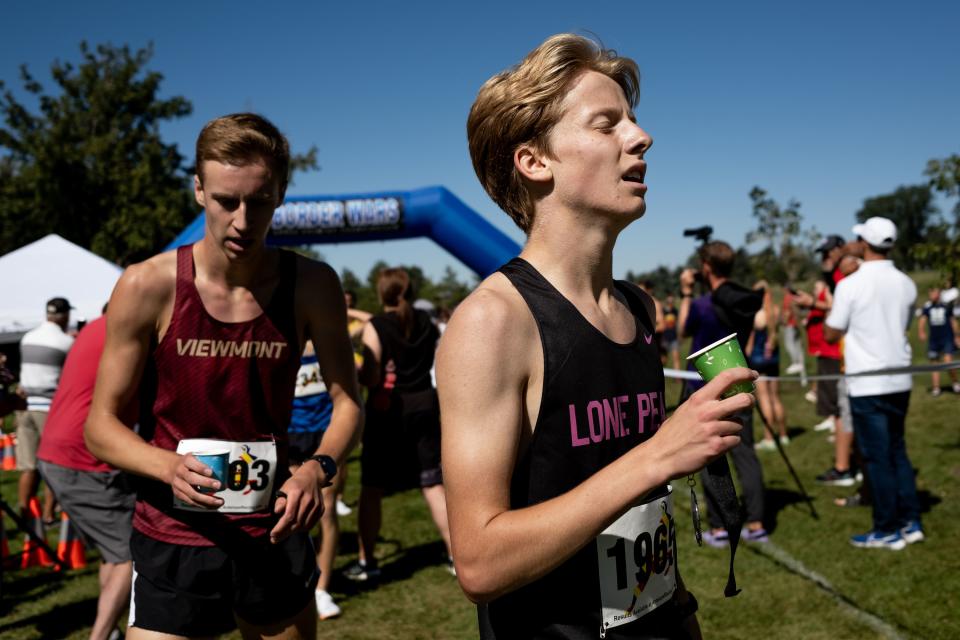 Runners recover after the championship boys race at the Border Wars XC meet at Sugar House Park in Salt Lake City on Saturday, Sept. 16, 2023. | Spenser Heaps, Deseret News