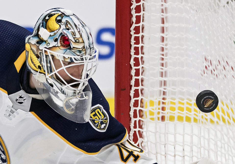 Buffalo Sabres goalie Carter Hutton watches the puck bounce off the side of the net during the second period of an NHL hockey game against the Vancouver Canucks, Saturday, Dec. 7, 2019, in Vancouver, British Columbia. (Darryl Dyck/The Canadian Press via AP)