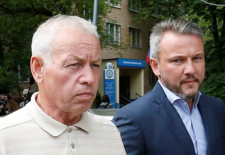 Former driver of a snow plow at Vnukovo airport and suspect Vladimir Martynenko (L), walks after attending a preliminary hearing on the air accident, which resulted in the death of Christophe de Margerie, the chief executive of Total company, at the Solntsevo District Court on the suburbs of Moscow, Russia, July 14, 2016. REUTERS/Sergei Karpukhin