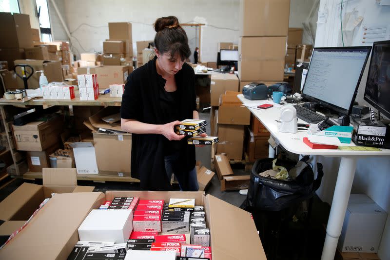 An employee prepares an order for Amazon at Porona warehouse in Bruay-sur-l'Escaut