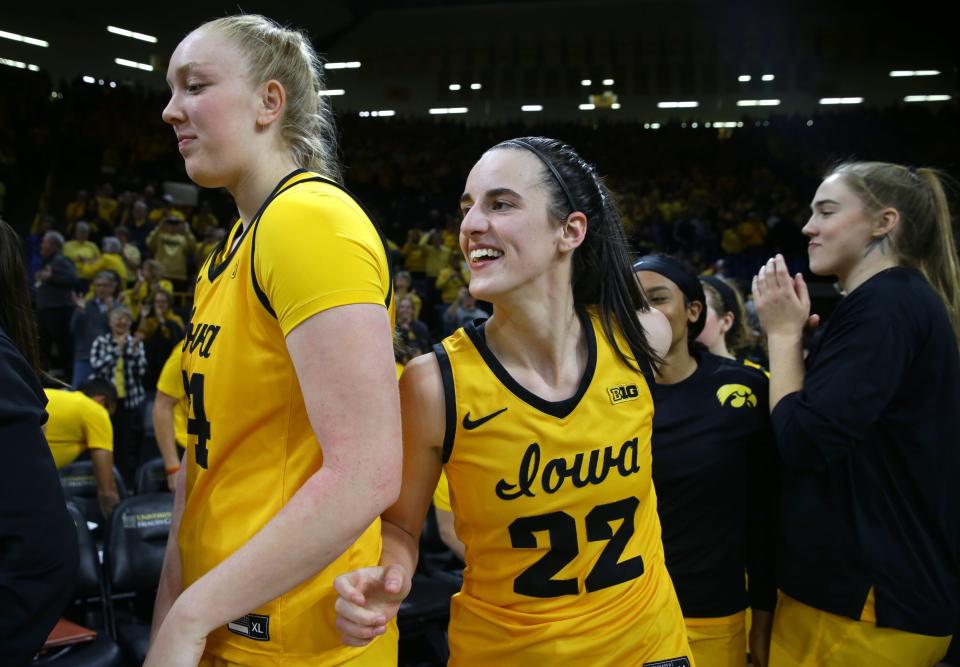 Caitlin Clark (22) and the Iowa Hawkeyes are the hottest ticket in town at home and on the road in the Big Ten.
