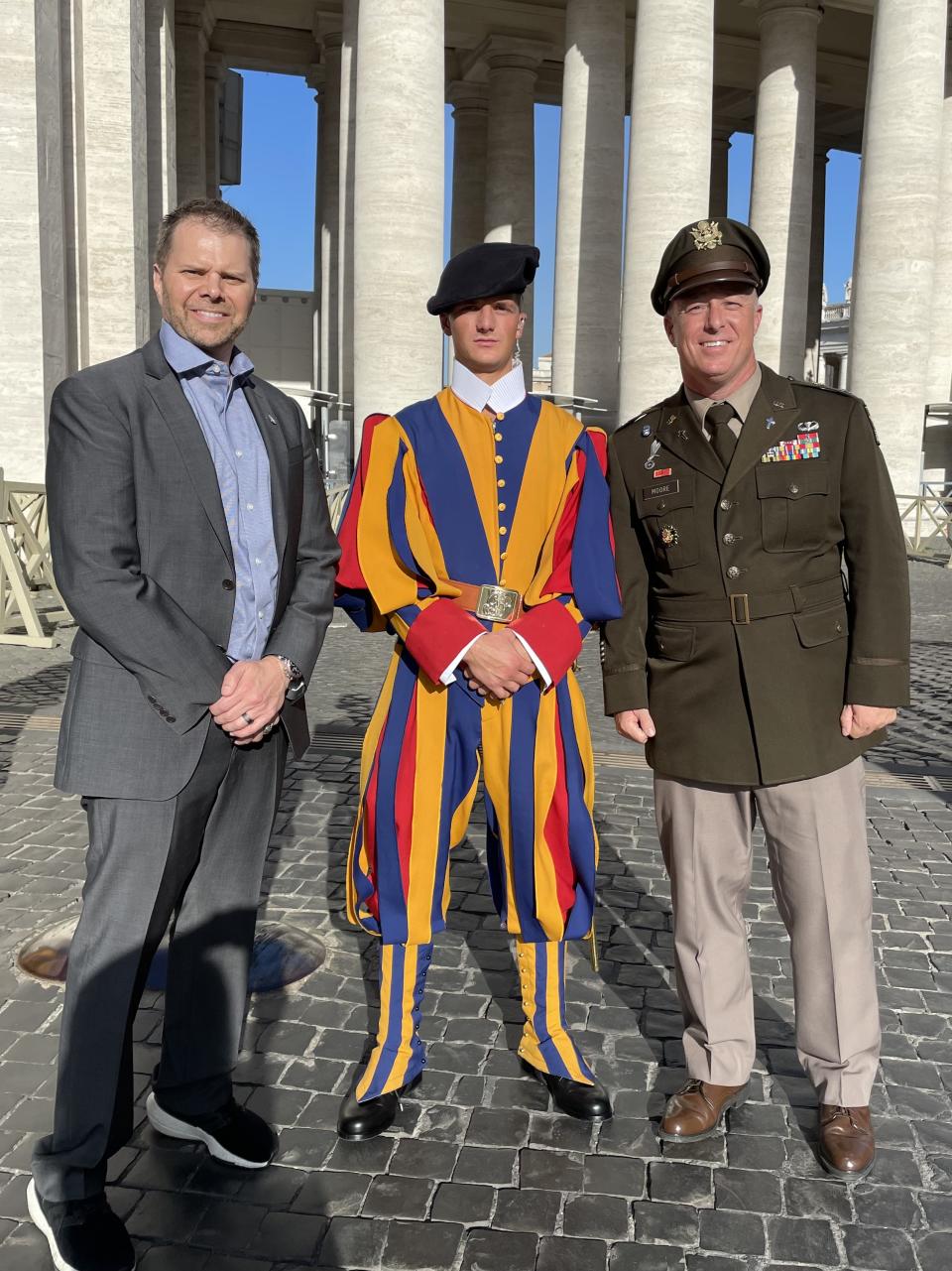 Director Rich Hull (L) and Chaplain (Lt. Colonel) Brandon Moore, Chief of Recruiting for the US Army Chaplain Corps, flank a Pontifical Swiss Guard at the Vatican.