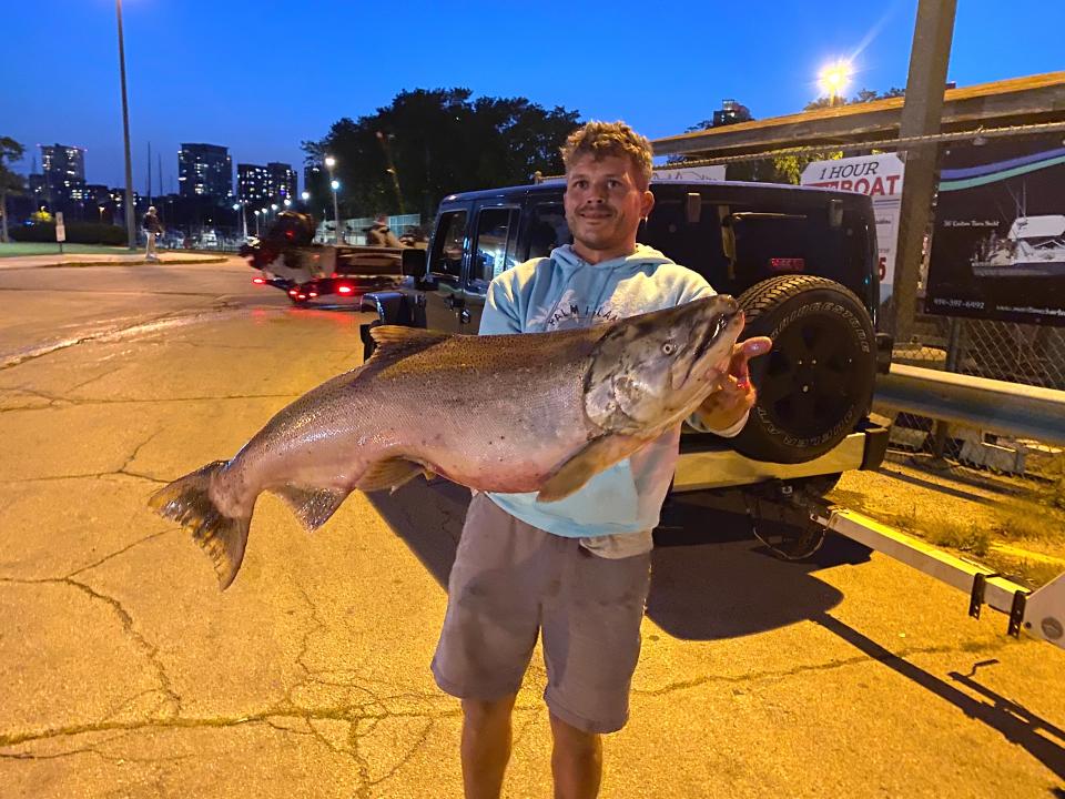 Blake Jarrett of Elkhorn holds a chinook salmon he caught Thursday while fishing in the Milwaukee harbor. The fish was 43.5 inches long, had a girth of 25.25 inches and was estimated at 38 pounds.