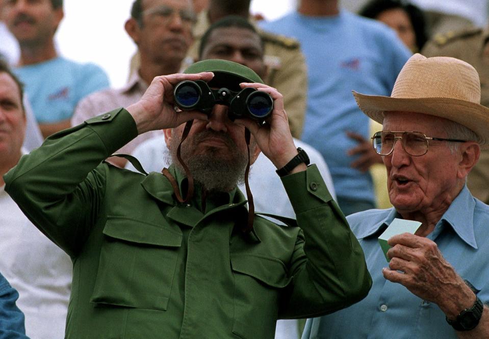 FILE - In this May 1, 1999 file photo, Vice President Jose Ramon Fernandez, right, stands with Cuban leader Fidel Castro who watches May Day festivities at Revolution Plaza in Havana, Cuba. Fernandez, a career soldier who joined Cuba's 1950s Revolution and became a prominent collaborator with the Castro brothers, died on Sunday, Jan. 6, 2019, according to official media. He was 95. (AP photo/Jose Goitia, File)