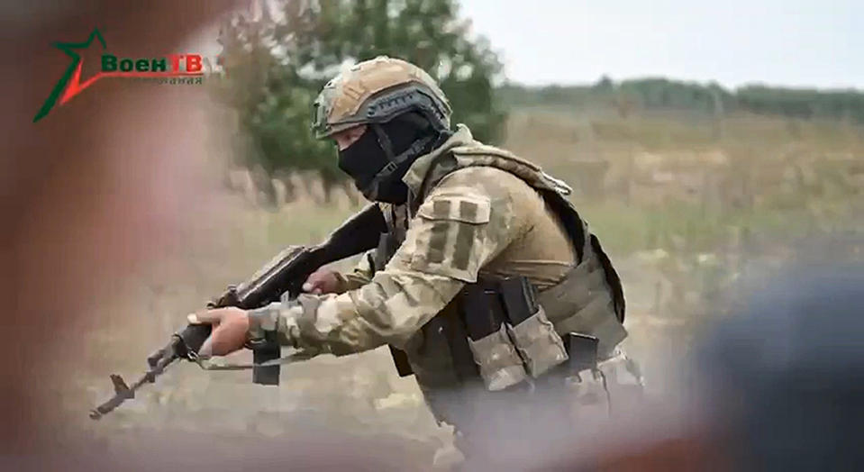 In this photo taken from video released by Belarusian Defense Ministry via VoenTV on Friday, July 14, 2023, an instructor, member of the Wagner Group military company, shows his skills to Belarusian soldiers during a training near Tsel village, about 90 kilometers (about 55 miles) southeast of Minsk, Belarus. Mercenary fighters from the Wagner private military company are training Belarusian soldiers in Belarus, the country's Defense Ministry said Friday. Russian President Vladimir Putin said he offered the Wagner private military company the option of continuing to serve as a single unit under their same commander. (Belarusian Defense Ministry via VoenTV via AP)