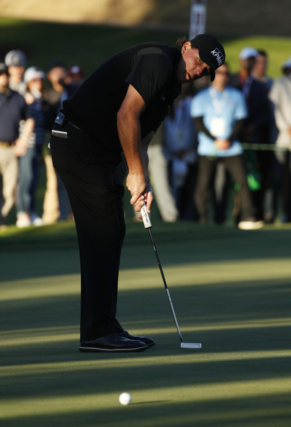 Phil Mickelson watches a putt on the 16th green during a match against Tiger Woods at Shadow Creek golf course Friday, Nov. 23, 2018, in Las Vegas. (AP Photo/John Locher)