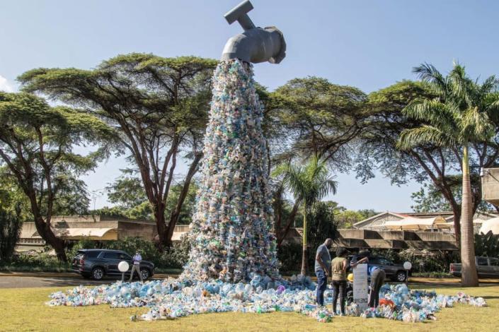 People are seen next to a plastic waste art installation by Canadian activist and artist, Benjamin von Wong on display outside the United Nations Environment Programme headquarters in Nairobi during UNEA conference. United Nations Environmental Assembly the world&#39;s foremost environmental decision-making body kicked off yesterday with opening remarks by its president Espen Barth Eide who reiterated for a multilateral action to end plastic pollution. Rwanda and Peru had proposed a legally binding draft resolution with a plastic full life cycle approach.