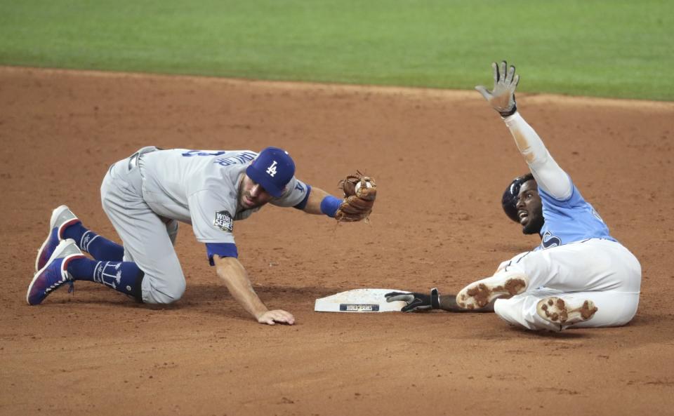 Chris Taylor tags out Tampa Bay Rays' Randy Arozarena during the third inning.