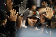 San Francisco Giants' Buster Posey celebrates his three-run home run with teammates in the dugout during the eighth inning of a baseball game against the Los Angeles Dodgers Friday, May 28, 2021, in Los Angeles. (AP Photo/Marcio Jose Sanchez)