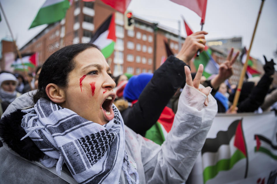 A participant chants slogans for the freedom of Gaza during a demonstration under the slogan "Germany-wide solidarity with Palestine" in Berlin, Germany, Saturday Dec. 23, 2023. (Christoph Soeder/dpa via AP)