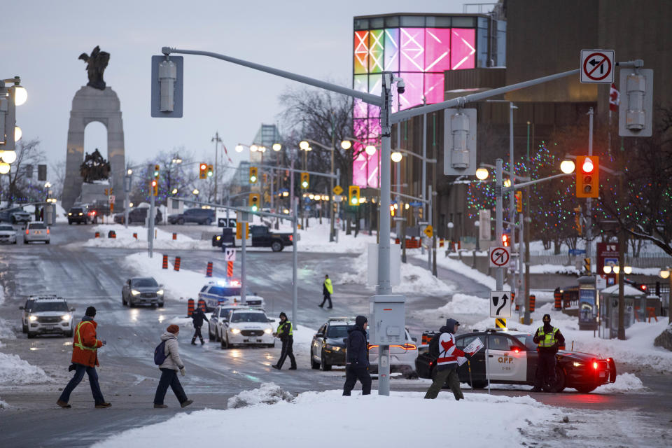 Police work at a checkpoint after authorities took action to clear a trucker protest that was aimed at COVID-19 measures before growing into a broader anti-government protest and occupation, in Ottawa, on Sunday, Feb. 20, 202. (Cole Burston/The Canadian Press via AP)