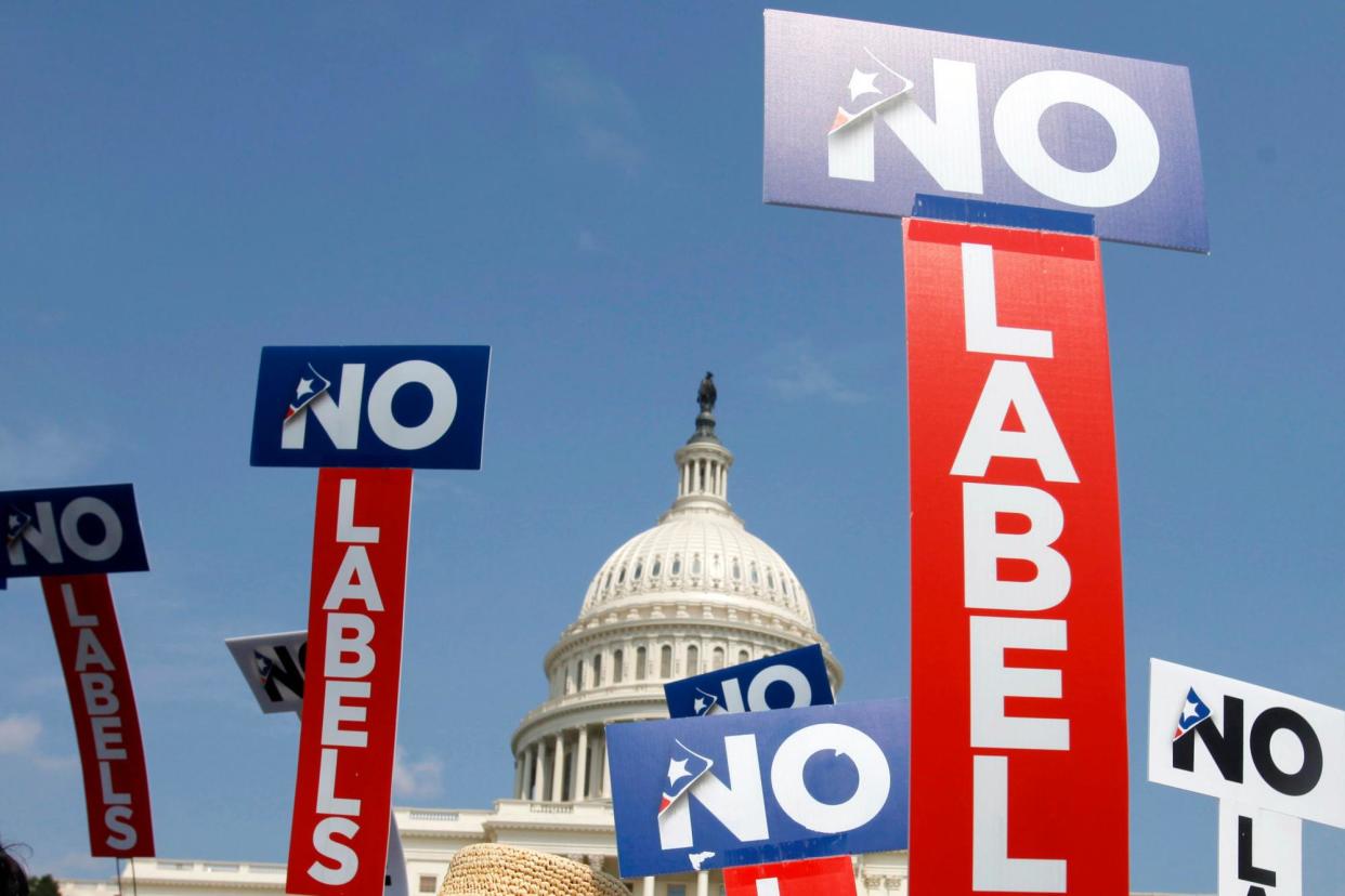 <span>People with the group No Labels hold signs during a rally in Washington DC.</span><span>Photograph: Jacquelyn Martin/AP</span>