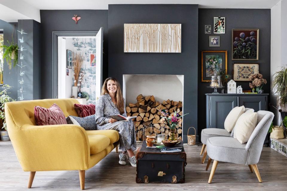 hayley baty sitting by the fire in her living area