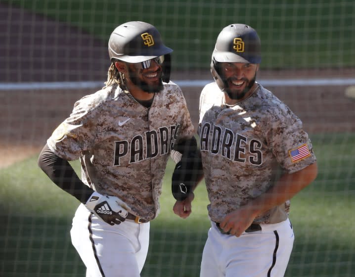 San Diego Padres' Fernando Tatis Jr. and Eric Hosmer celebrate after scoring