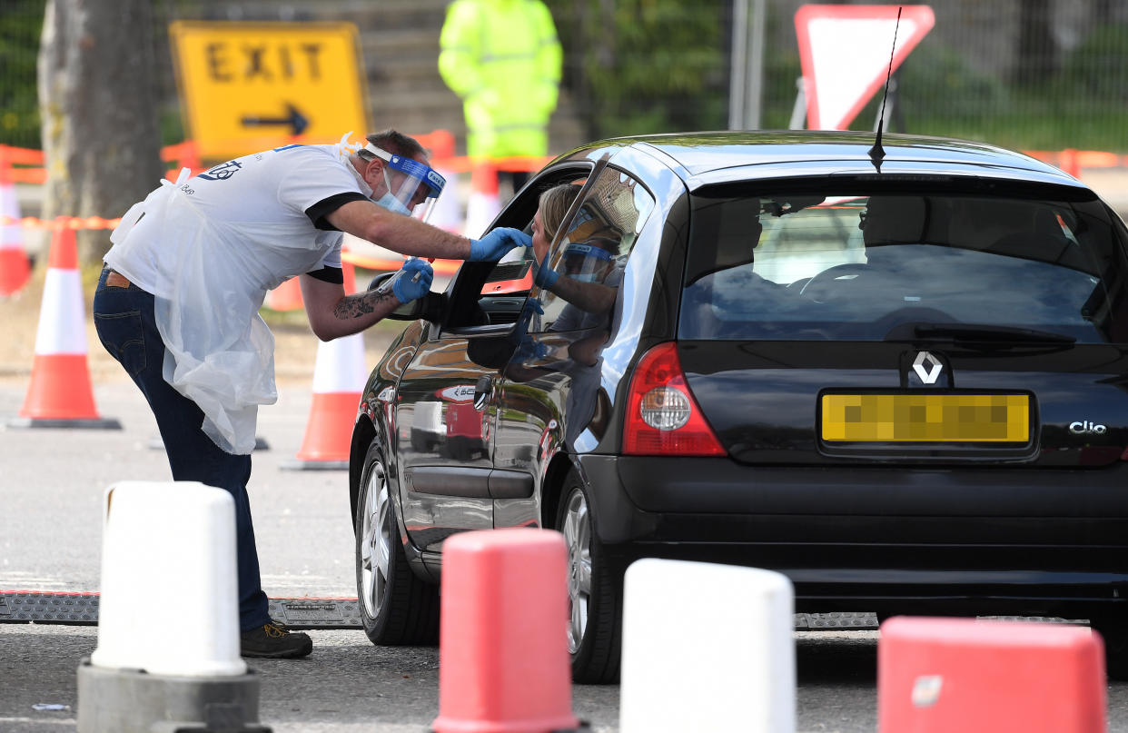 Numberplate pixelated by PA picture desk. A medical worker takes a swab at a drive-in coronavirus testing facility at the Chessington World of Adventures Resort in south west London, as the UK continues in lockdown to help curb the spread of the coronavirus.