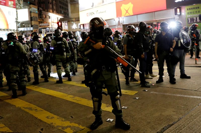 Riot police disperse pro-democracy demonstrators gathering to commemorate the three-month anniversary of an assault by more than 100 men on protesters, commuters and journalists, in Hong Kong