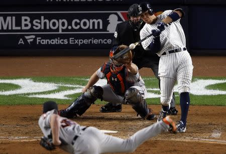 Oct 16, 2017; Bronx, NY, USA; New York Yankees right fielder Aaron Judge (99) hits a three run home run during the fourth inning against the Houston Astros during game three of the 2017 ALCS playoff baseball series at Yankee Stadium. Mandatory Credit: Adam Hunger-USA TODAY Sports