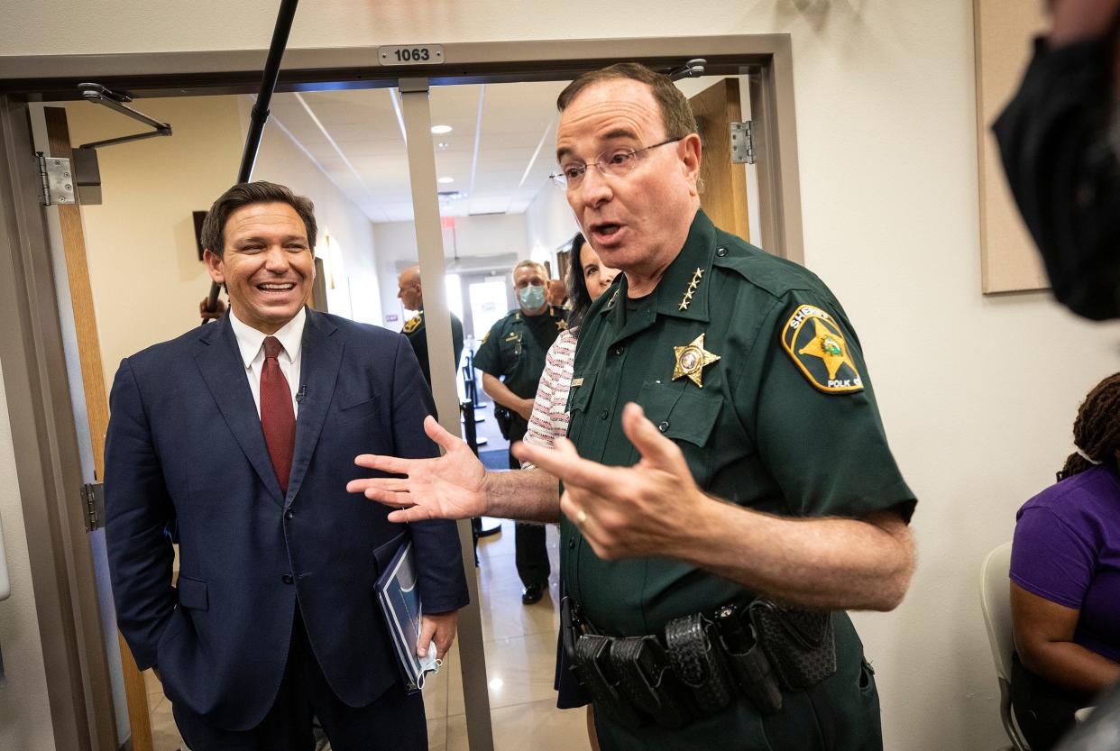 Polk Sheriff Grady Judd and Gov. Ron DeSantis talk to the media before a news conference in Polk County in March 2021. Judd was one of two Florida sheriffs who joined DeSantis on a surprise trip to the U.S. border with Mexico on Wednesday and gave the governor a glowing assessment, while stopping short of an official endorsement.