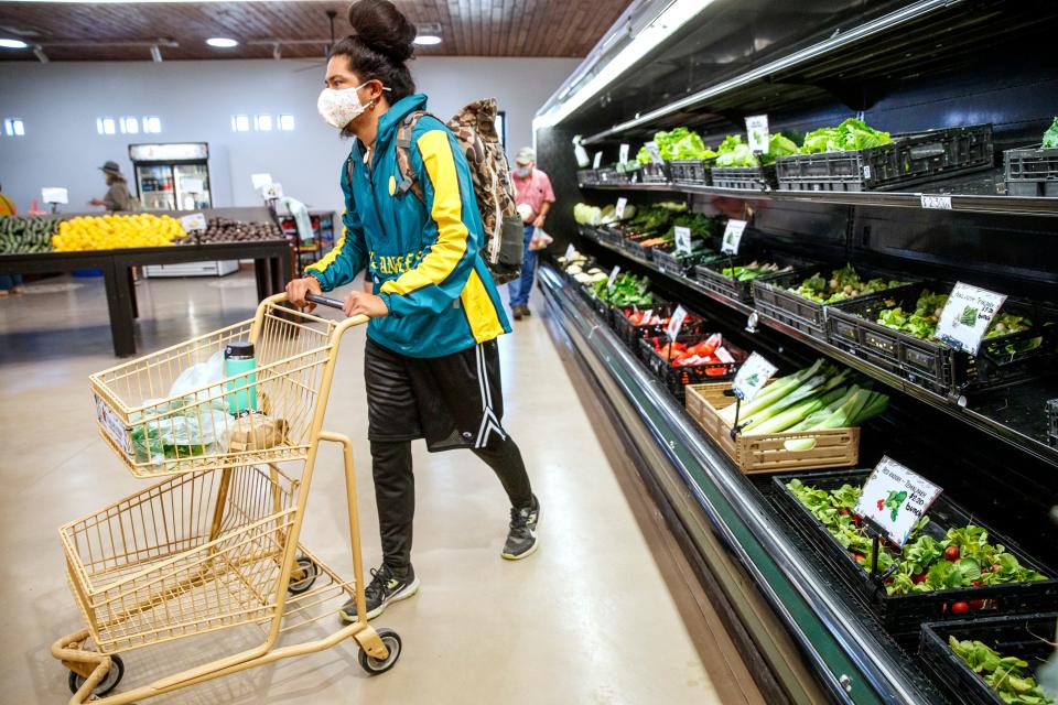 Jesse Portillo of Los Angeles shops at the Temalpakh Farm Market in Coachella, Calif., on Tuesday, Jan. 18. 2022.