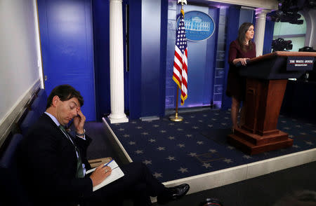 Deputy White House Press Secretary Hogan Gidley listens as White House Press Secretary Sarah Huckabee Sanders answers reporters' questions about the New York Times report on the Trump family's taxes during a news conference in the White House briefing room in Washington, U.S., October 3, 2018. REUTERS/Leah Millis
