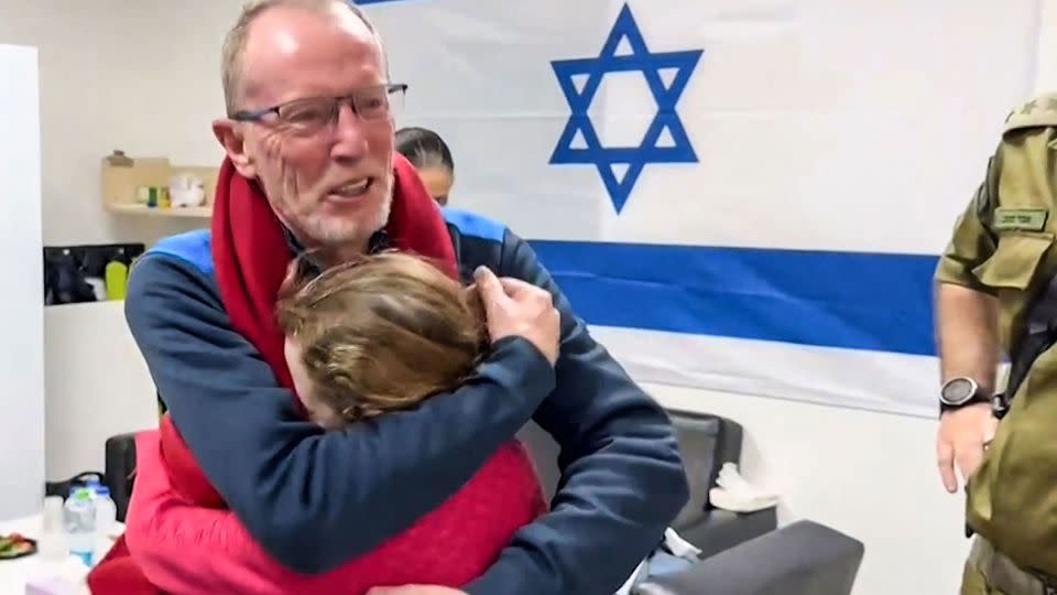 Emily Hand embraces her father at a hospital in Israel after being released by Hamas on November 25. - IDF/AFP via Getty Images