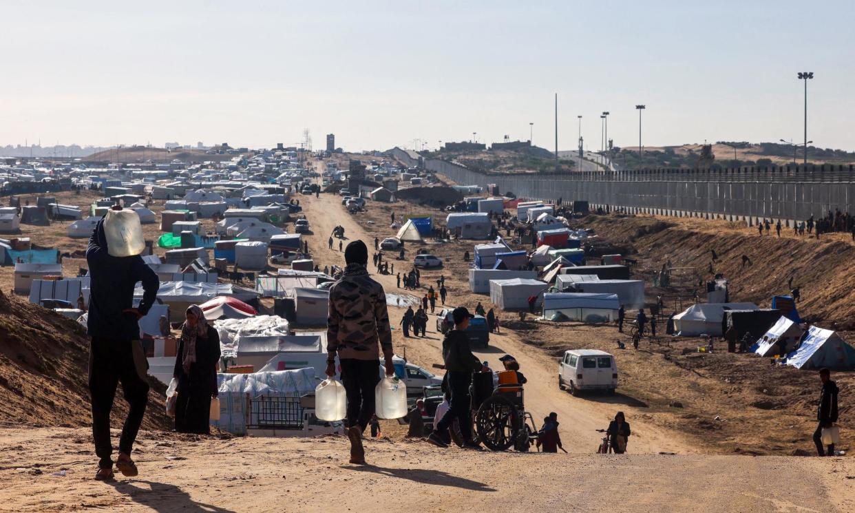 <span>A camp for displaced Palestinians near the border with Egypt. State Labor MPs have called on the federal government to ensure a ‘clear, consistent approach to supporting people to escape from Gaza’.</span><span>Photograph: AFP via Getty Images</span>