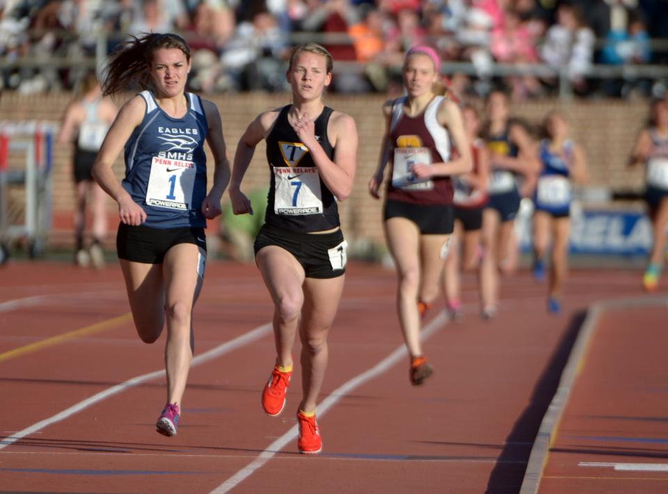 Jamie Phelan of St. Mary's (1) defeats Reagan Anderson of Tatnall (7) to win the girls championship mile, 4:50.60 to 4:50.66, in the 119th Penn Relays at Franklin Field in 2013.