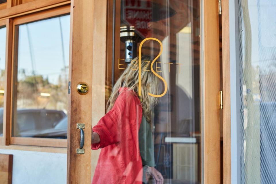 Eszett co-owner Sabrina Bezaire walks through the glass front door of Eszett