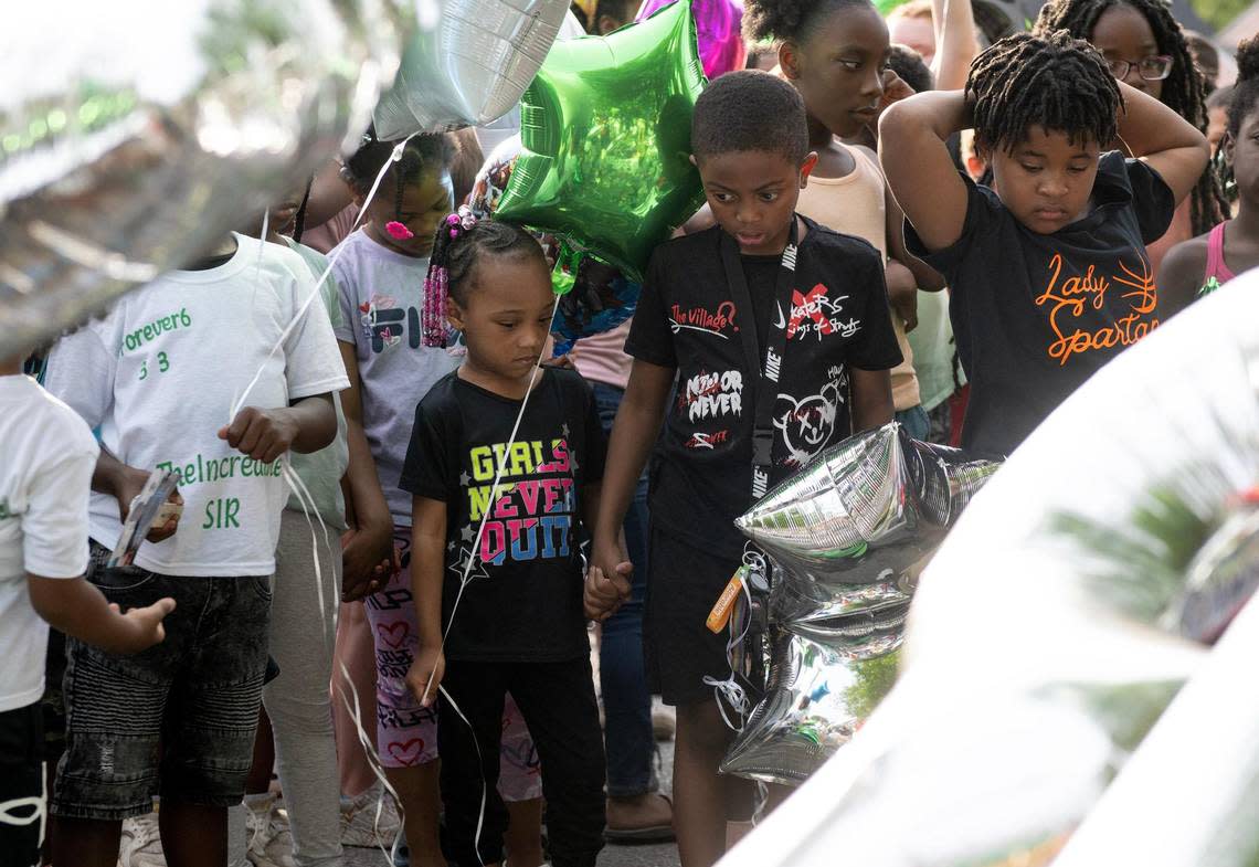 Children look at a memorial during a vigil for 6-year-old Sir’Antonio Brown on Wednesday, May 10, 2023, in Kansas City, Kan. Brown was killed May 3 while playing outside his home.