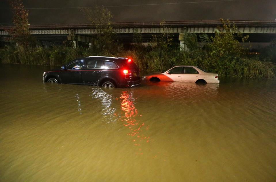 Cars sit stalled on the flooded roadway between Frawley Stadium and I-95 in Wilmington Friday evening, Oct. 29, 2021.
