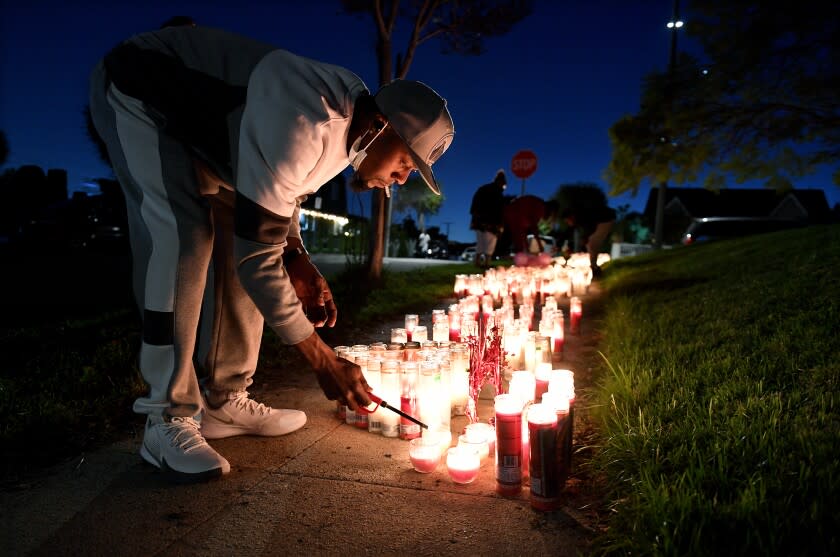 Inglewood, California January 24, 2022: Marlon Hamilton father of victim Marneysha, lights a candle in her honor after four people were gunned down a birthday party in Inglewood.(Wally Skalij/Los Angeles Times)