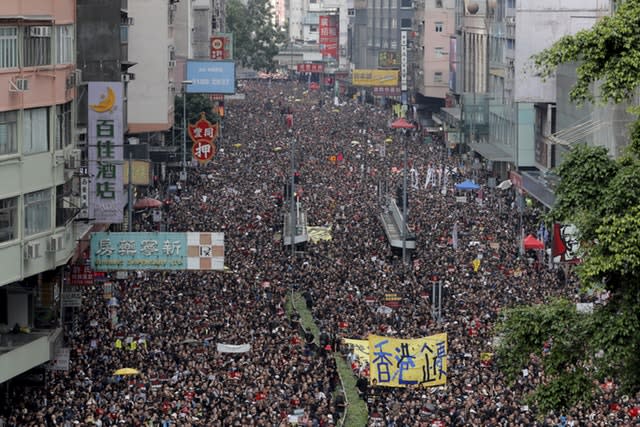 Tens of thousands of protesters march through the streets in Hong Kong