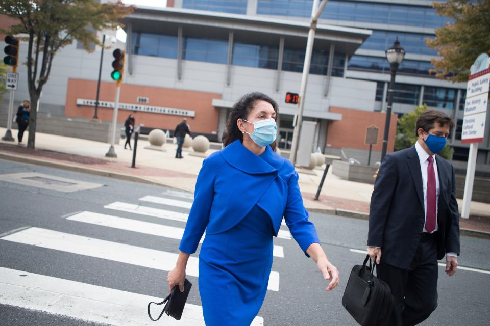 Delaware state Auditor Kathy McGuiness, left, leaves the New Castle County Courthouse with her attorney Steve Wood Tuesday, Oct. 12, 2021. McGuiness was indicted Monday on criminal charges that she hired and supervised her daughter in a do-nothing state job, that she circumvented state contracting laws to shield public payments to a political campaign group from regulator scrutiny and that she spied on and discriminated against employees who questioned her conduct.